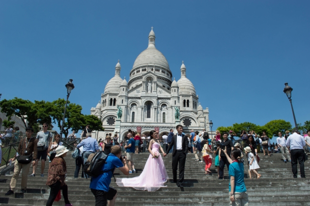 People staging a wedding on the steps of the Sacre Coeur